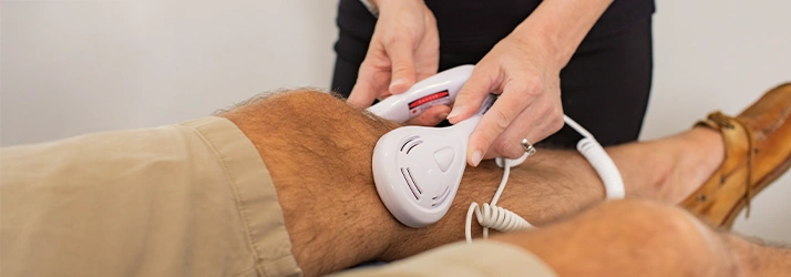 Chiropractic Saint Johns FL Laser Therapy On Knee Laser Therapy Treatment On A Patient's Knee